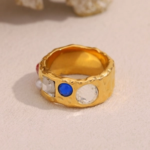 Detail of 18K gold-plated irregular hammered ring with multi-color gems and pearl