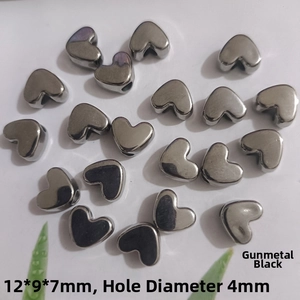 Macro view of gun black heart-shaped metal beads with 4mm hole for DIY jewelry making