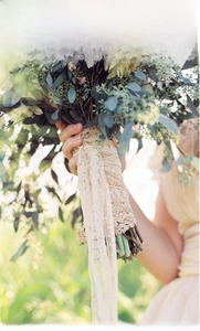Detailed view of ivory white lace ribbon with floral texture on a wedding flower bouquet