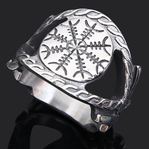 Macro shot of vintage silver Viking Vegvisir ring with intricate wolf head engravings