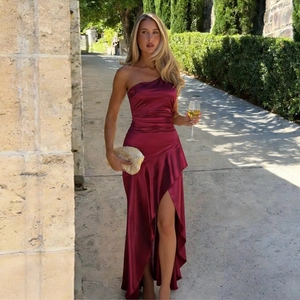 Detail of elegant burgundy satin dress with one-shoulder design and side slit