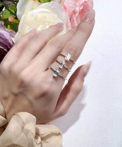 Three-color emerald cut moissanite rings in silver, gold, and rose gold finishes