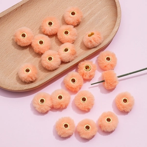 Detail showing 20mm soft coral faux rabbit fur pompom beads with metal center hole