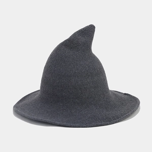 Close-up of dark grey knitted wizard hat showing spiral texture and curved pointed top