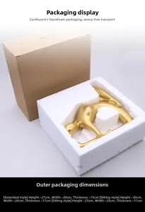 Secure packaging detail for golden yoga statues with protective foam and cardboard boxes