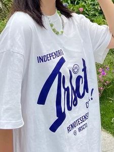 Detailaufnahme von blauem Buchstabendruck und Smiley-Grafik auf einem weißen Baumwoll-T-Shirt