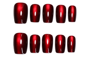 Detail of 10-piece dark red cat-eye press on nails with shimmering metallic finish