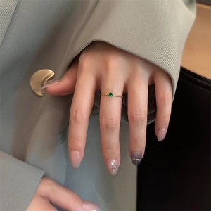 Slim 18k gold plated titanium ring with textured band and small green emerald gemstone