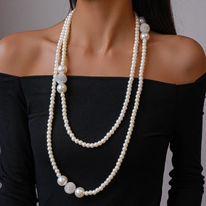 Close-up of double-layer faux pearl necklace with silver crystal pavé balls on a model