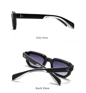 Detail view of black rectangular sunglasses with golden star rivets and purple gradient lenses
