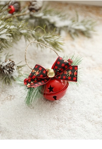 Macro detail of red Christmas bell with plaid bow, pine needles and Merry greeting