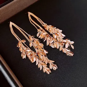 Elegant gold plated wheat tassel earrings with leaf charms in a luxury black jewelry box