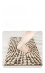 Close-up of beige chenille bath mat with dense massage granules and slip-resistant texture