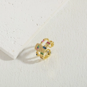 Detail of double-layer open ring with geometric pavé stones and colorful gemstones