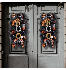 Detail of Halloween BOO door wreaths with black mesh and orange polka dot ribbons