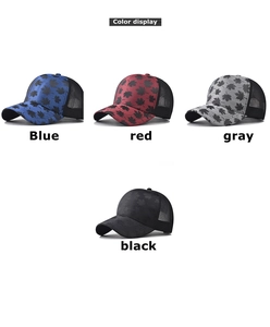 Close-up of four plaid baseball caps with maple leaf patterns and mesh backs in multi-colors