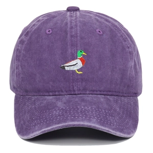Close-up of duck embroidery on washed purple cotton six-panel retro baseball cap