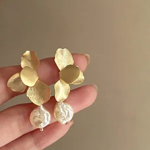 Baroque pearl earrings with golden flower petals and brushed metal texture design