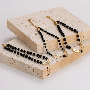 Gold finish bracelet set featuring infinity heart and heartbeat charms on textured stone