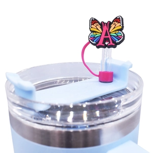 Close-up of rainbow butterfly straw cover with pink letter A on a blue tumbler lid