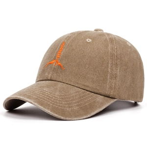 Macro view of washed vintage cotton baseball cap featuring orange geometric embroidery