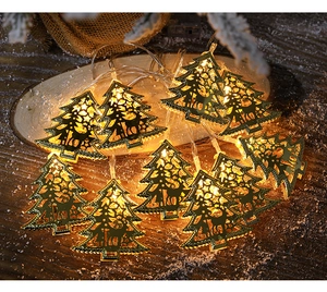 Close-up of golden hollow metal Christmas tree LED string lights on a wooden base