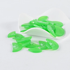 Macro detail of translucent PVC kiwi fruit slices with seeds for DIY cake decoration