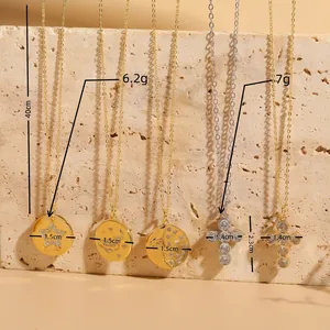 14K gold plated pendant necklaces with zircon stars, moon, and cross on stone background
