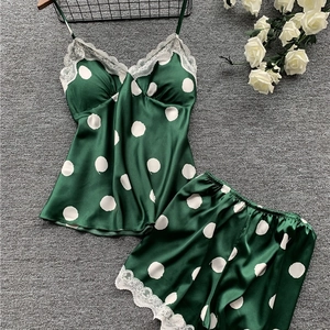 Women's dark green satin pajama set with white polka dots and delicate lace trim