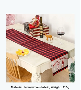 Detail of red and black buffalo plaid Christmas table runner with gnome and Merry Christmas text