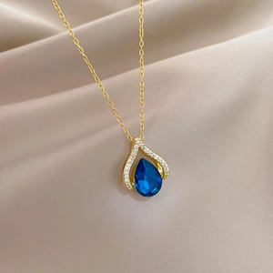 Golden titanium necklace with blue water-drop gem and diamonds on champagne silk