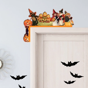 Detail of vintage Halloween wooden door corner decor featuring witches and pumpkin