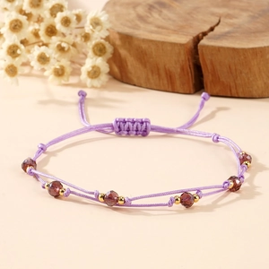 Handmade purple woven rope bracelet with crystal beads and adjustable pull closure