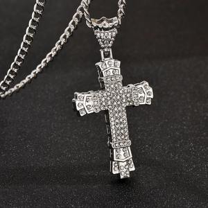 Macro shot of sparkling rhinestones and silver metal texture on a vintage cross pendant