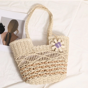 Handmade woven straw tote bag with purple flower charm for summer beach vacation