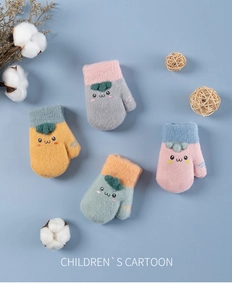 Flat lay of warm plush knit children's mittens with cute carrot cartoons in various colors