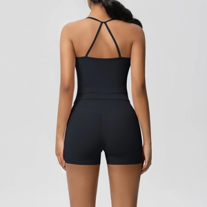 Detail of cross back straps on black athletic tank top and yoga shorts for women