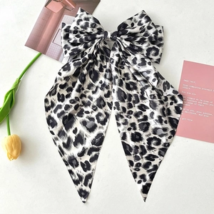 Large leopard print hair bow clip with long ribbons and a smooth satin texture