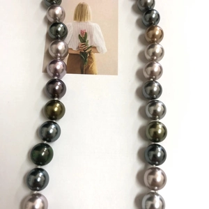 Close-up of multicolored Tahitian style pearl necklace with peacock green and grey tones