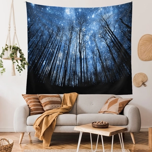 Detailed view of nature tapestry featuring starry sky and forest silhouette over sofa