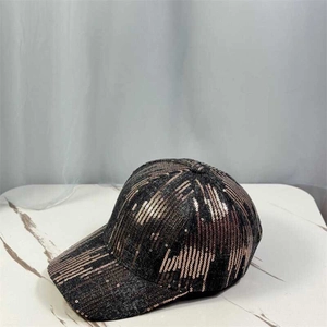 Detailed view of the sparkling bronze sequins on a classic curved brim baseball cap