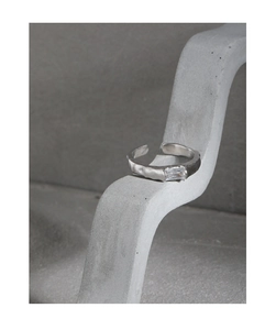 Detail of S925 silver open ring with irregular texture and rectangular zircon stone