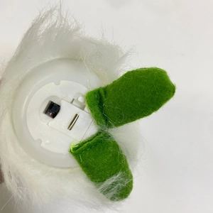 Detailed base view showing electronic battery compartment and switch for plush doll