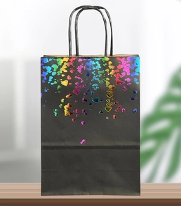 Detail of black paper gift bag featuring holographic rainbow foil hearts and twisted handles