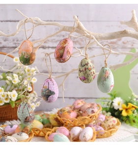 Easter egg hanging ornaments with floral patterns and twine loops on white branches