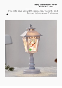 Detail of a white vintage street lamp water globe featuring a snowman and falling snow
