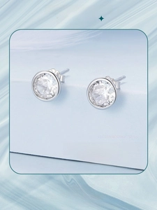 Macro shot of S925 sterling silver stamp and sparkling cubic zirconia bezel stud earrings