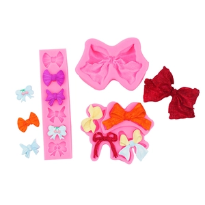 Macro detail of pink silicone bow molds for fondant DIY craft with colorful resin samples