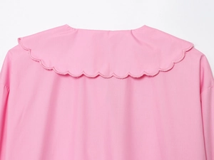 Close-up of pink cotton blouse neckline showing delicate scalloped edge embroidery