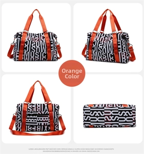 Detail view of large orange fitness travel bag showing pattern, straps, and base angles